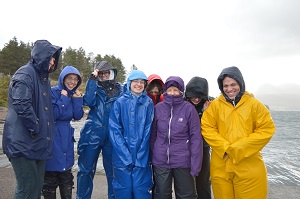 Students in waterproofs by a sea loch