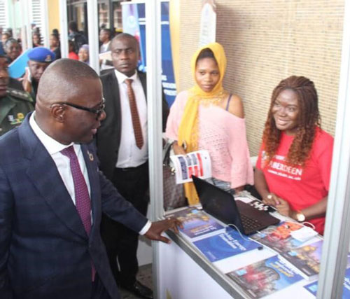 In-Country Officer Blessing Egbe, chatting with the Governor of Lagos State, His Excellency Babajide Sanwo-Olu druing the October 2019 International Week in the University of Lagos, Nigeria.

