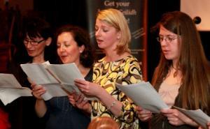 Four singers holding song sheets.