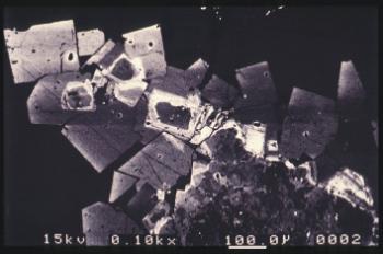 Geochemical analysis of the rocks at Rhynie suggest there is a correlation between the abundance of pyrite and gold. Ion probe analysis of pyrite crystals in altered andesites from the basin margin fault zone indicates most of the gold is probably located in zones of arsenian pyrite (see inset right).