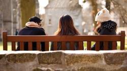 3 students sitting on a bench