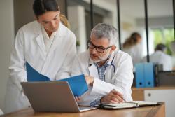 Doctors looking at a document