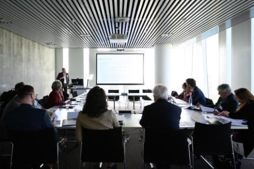 Workshop attendees in a room around a table