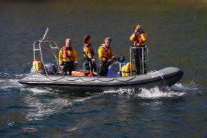 Members of the team carrying out a photo-ID survey on our boat Rona.