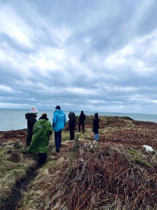 Group of people standing by the sea