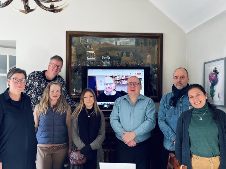 The Project Group standing next to each other in a conference room