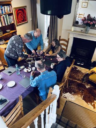 Workshop, people around a table looking at objects