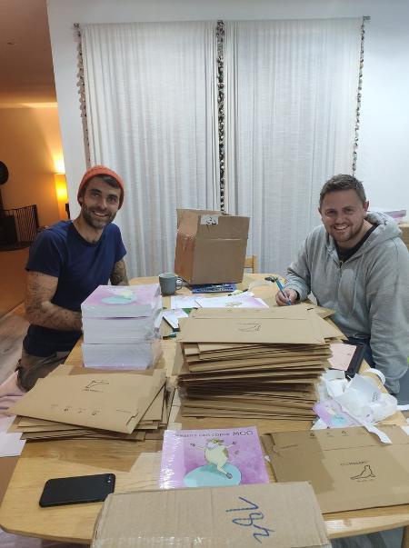 Matt Kinghorn and Euan Wemyss posting copies of the Dreams Can Come Moo book