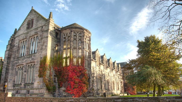 An Image of New Kings Building with red ivy up the walls