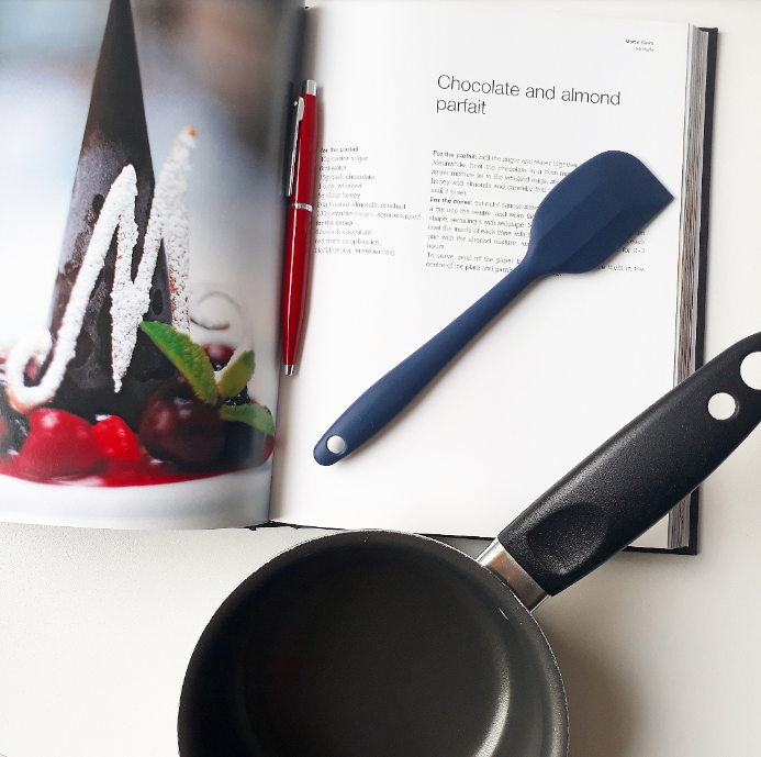 flat lay image ofrecipe book and pan