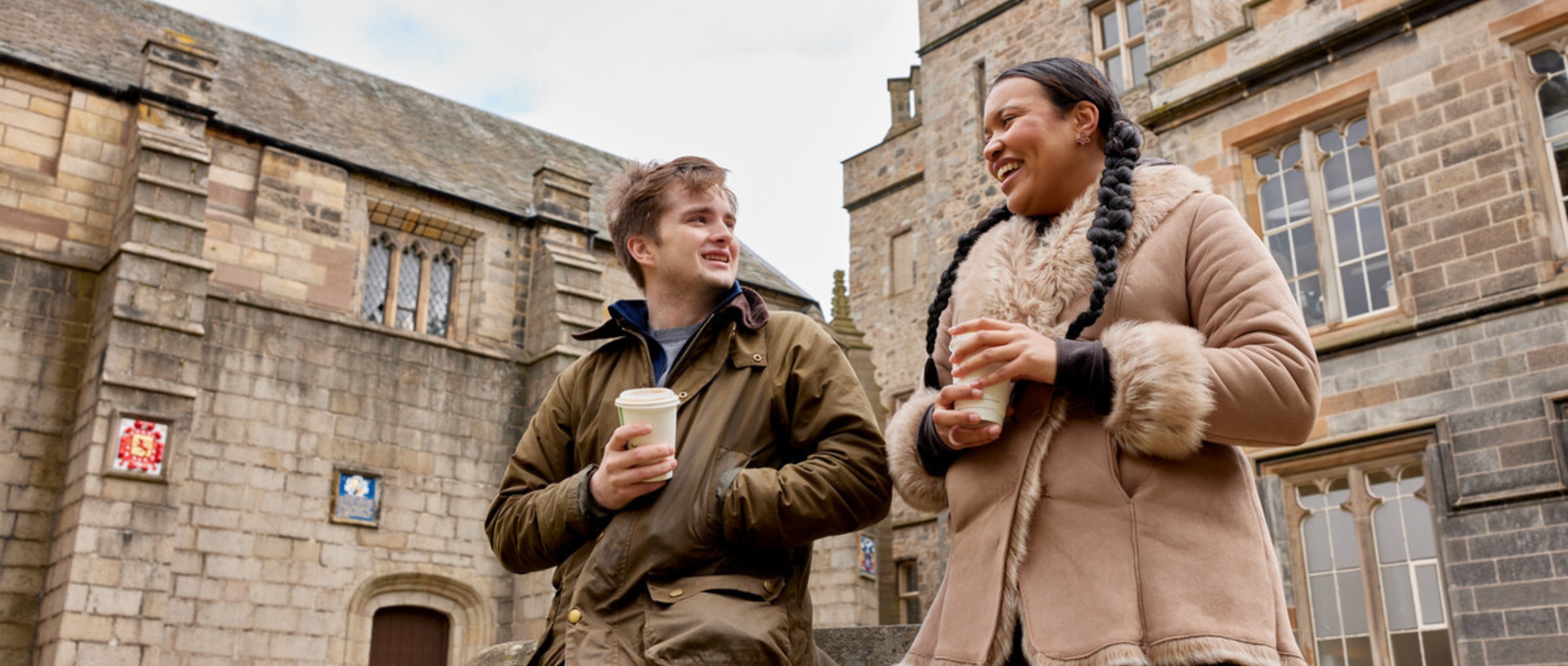 2 students in conversation in the Kings College Quad