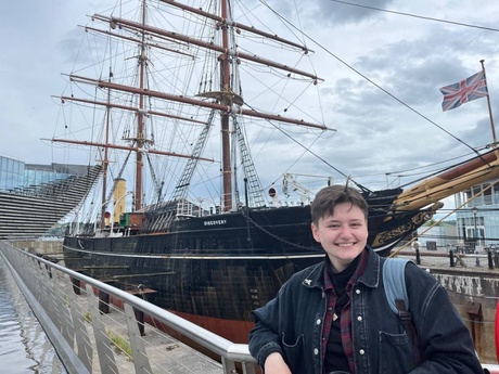 person in front of sailing boat