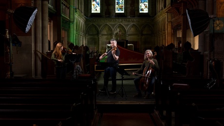 Musicians performing on stringed instruments in a church setting. Photo by Campbell Parker.