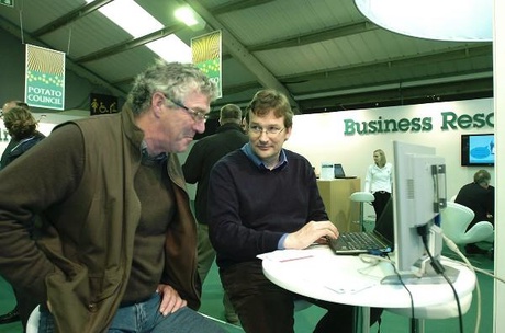 Dr Jon Hillier (right) demonstrates the Cool Farm Tool to a farmer
