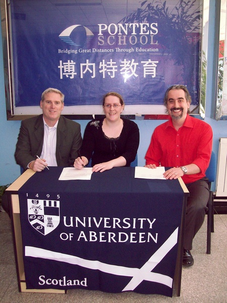 Ms Gemma Smith, Senior International Officer at Aberdeen, is pictured signing the agreement with Mr Shaun Carver and Mr Deryk Fournier, Founders of Pontes School