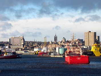 Offshore support vessels in Aberdeen Harbour with the cityscape in the background