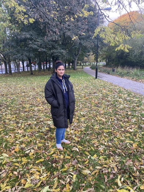 Faiza standing outside among trees