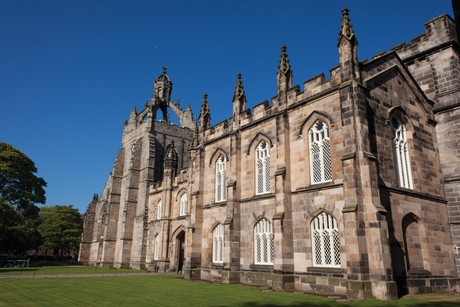 The exterior of King's College with a blue sky background
