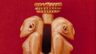 Carved ivory pendant, in the form of two human figures, back to back, from a village in Viti Levu, Fiji