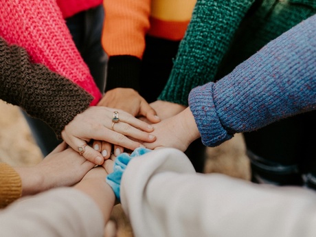 A group of people with their hands together
