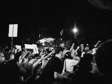 Black and white photo of people at a protest holding signs