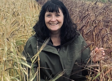 Professor Wendy Russell in a field of barley