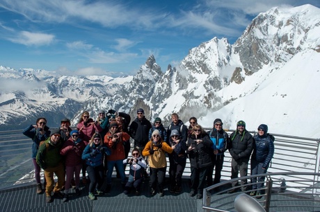 A group of people stand in front of Mont Blan