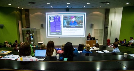 Students watching lecture in lecture theatre