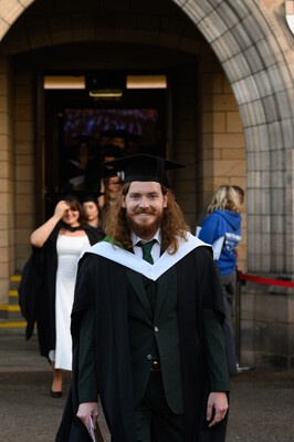 A person walking out of Elphinstone Hall after the ceremony