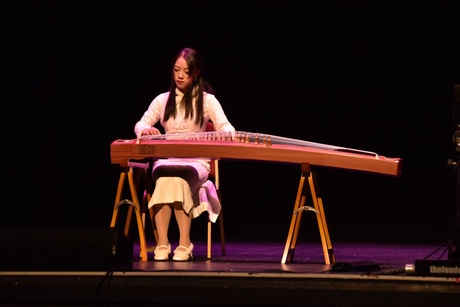 Woman playing the traditional Chinese instrument guzheng