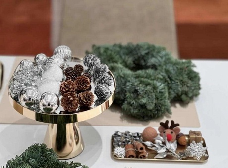 A table filled with Christmas decorations and wreaths