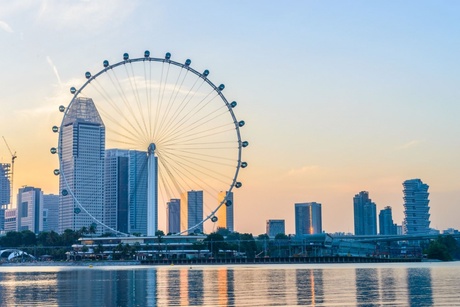 Singapore Flyer and city skyline at dusk