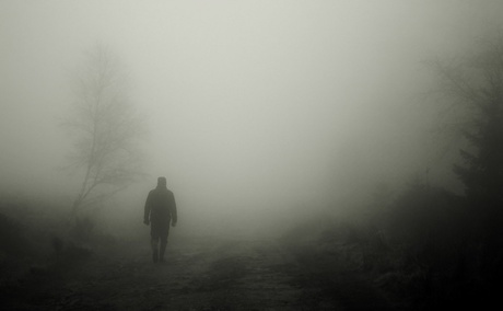 Man walking through fog