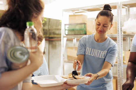 Female volunteer serving meals