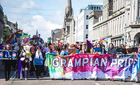 People parading down Union Street in Aberdeen carrying banners