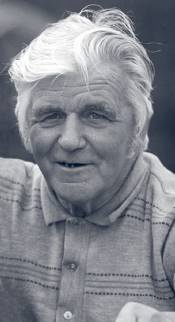 Man with white hair and polo shirt.