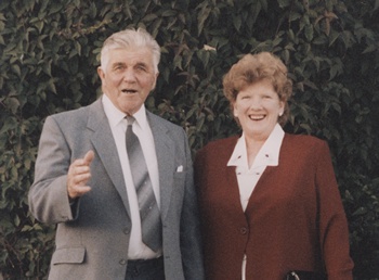 Man and woman pose outside