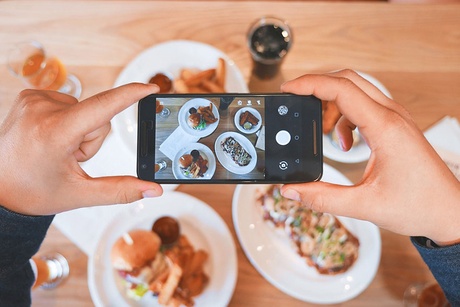 Someone taking a picture of food