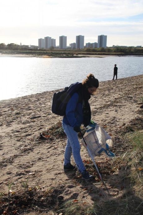 Person cleaning beach