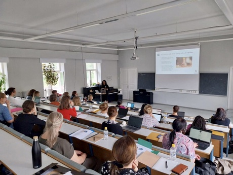 Dr Onyoja Momoh presents in front of an audience. Picture taken from back of Lecture Hall with only Dr Momoh's face being visible and recognisable.