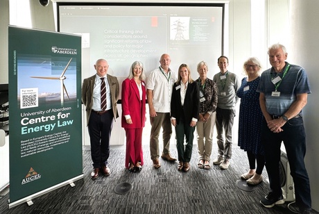 Picture of a group of people in front of a screen