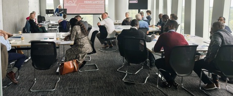 Photo of the workshop session, people sitting on tables in groups