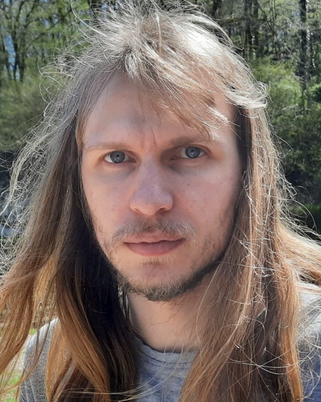 Joe Stollery, in front of a forest background