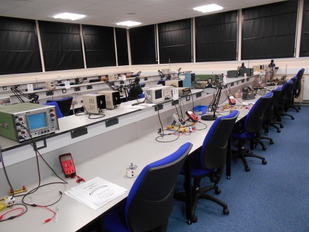 A physics lab showing a bench with oscilloscopes