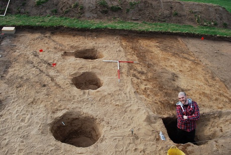 Student Joseph Tong excavating the palisade and post setting