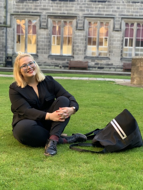 Ana sitting in the quad outside King's