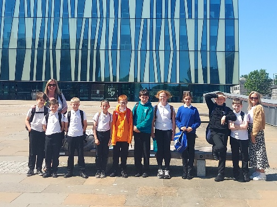 Pupils gathered outside the Sir Duncan Rice Library in the sunshine