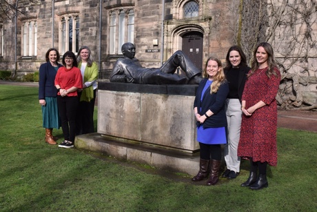 Image shows team standing outside New King's Building by sculpture