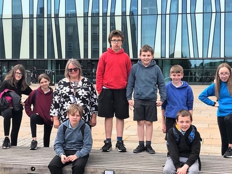 Some of the pupils and Pam outside the Sir Duncan Rice Library