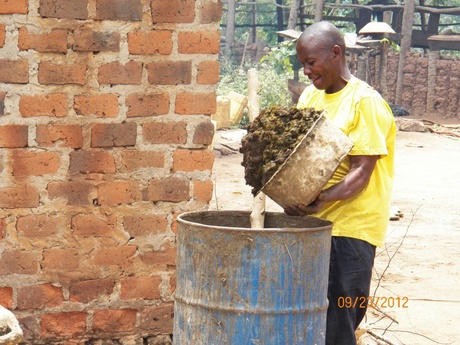 Animal waste being poured into a mixing tank